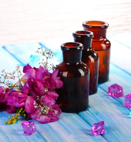 Spa oil and freesia on light background — Stock Photo, Image