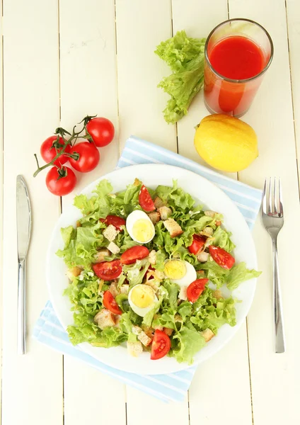 Caesar salad on white plate, on color wooden background — Stock Photo, Image