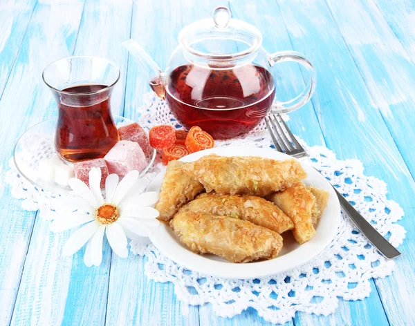 Sweet baklava on plate with tea on table — Stock Photo, Image