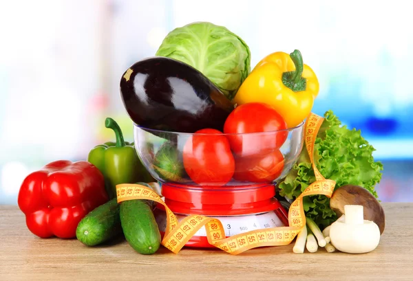 Fresh vegetables in scales on table in kitchen — Stock Photo, Image