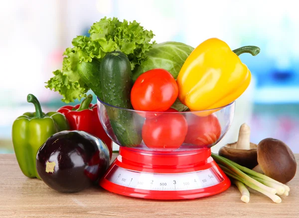 Fresh vegetables in scales on table in kitchen — Stock Photo, Image