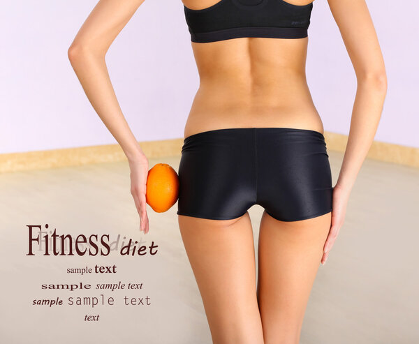 Beautiful female figure with orange on light background