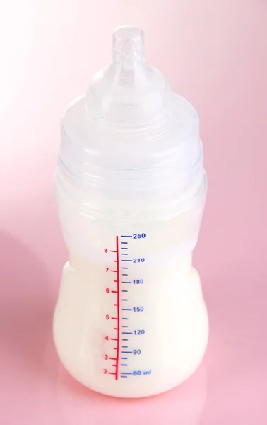 Bottle for milk formula on pink background — Stock Photo, Image