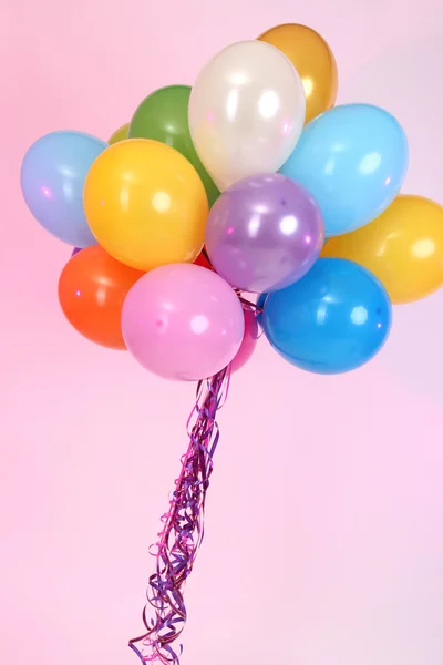 Many bright balloons on pink background — Stock Photo, Image