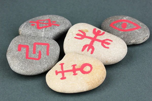 Fortune telling with symbols on stones on grey background — Stock Photo, Image