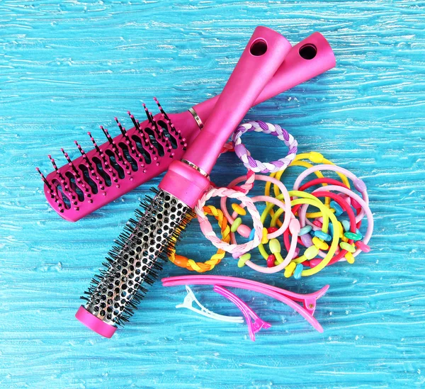 Scrunchies, hairbrush and hair - clip on a blue background — Stock Photo, Image