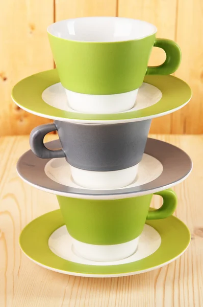 Three cups on wooden background — Stock Photo, Image