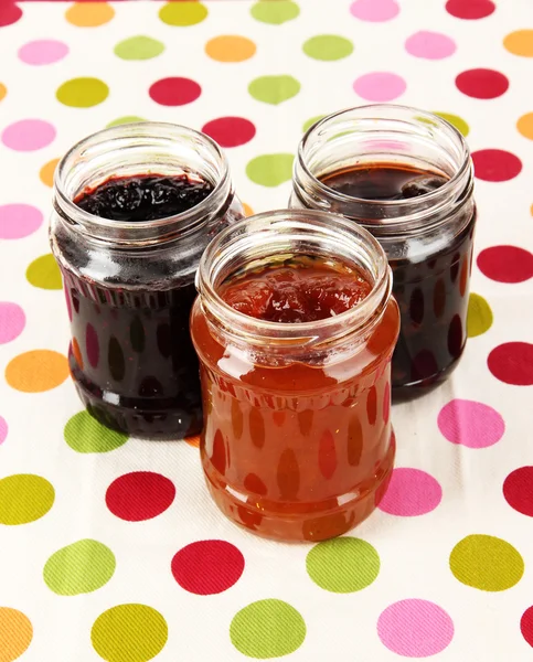 Tasty jam in banks on table — Stock Photo, Image