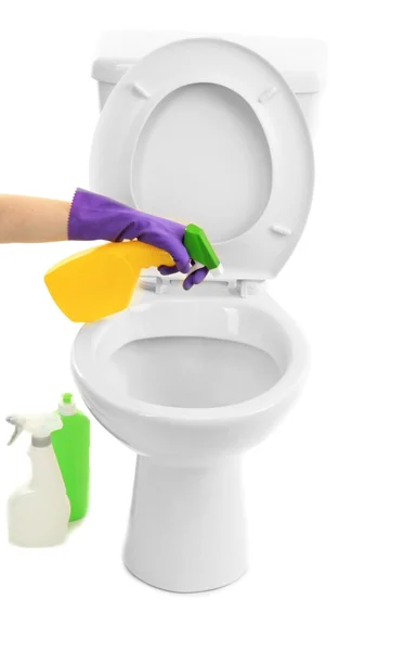 Woman hand with spray bottle cleaning a toilet bowl, isolated on white — Stock Photo, Image