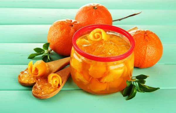 Orange jam with zest and tangerines on wooden desk on wooden table — Stock Photo, Image