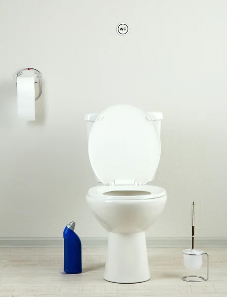 White toilet bowl and cleaner bottle in a bathroom — Stock Photo, Image