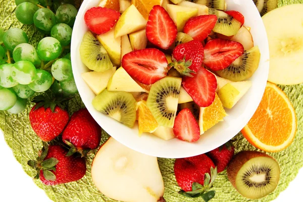 Useful fruit salad of fresh fruits and berries in bowl on napkin isolated on white — Stock Photo, Image