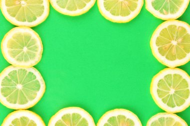 Lemon slices frame on color background