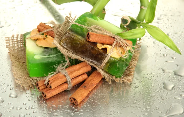 Hand-made soap and bamboo with drops, close up — Stock Photo, Image