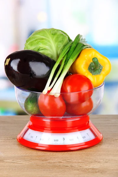 Fresh vegetables in scales on table in kitchen — Stock Photo, Image