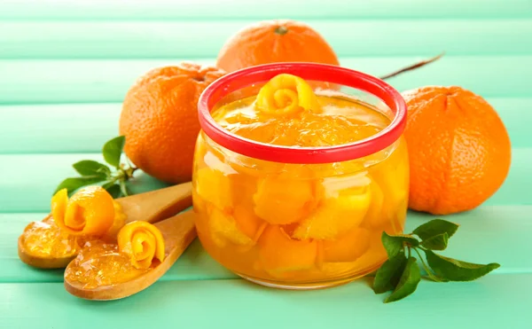 Orange jam with zest and tangerines on wooden desk on wooden table — Stock Photo, Image