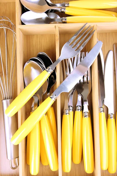 Checked cutlery in wooden cutlery box close up — Stock Photo, Image