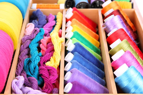 Colorful threads for needlework in wooden box close up — Stock Photo, Image