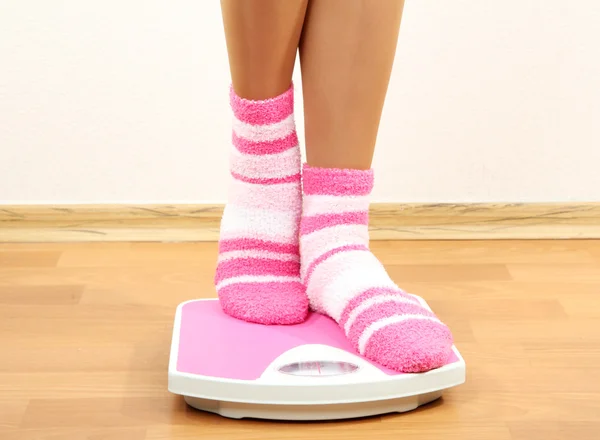 Feet on scales on floor in room — Stock Photo, Image