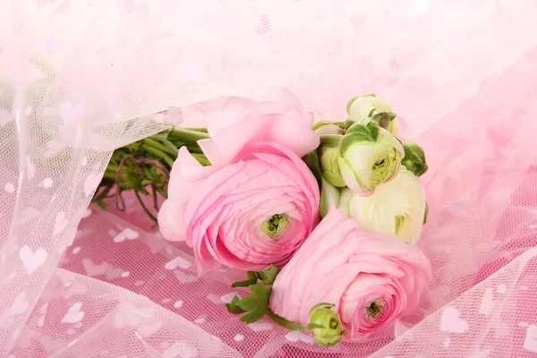 Ranunculus (persian buttercups), on pink cloth — Stock Photo, Image
