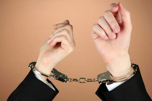 Man and woman hands and breaking handcuffs on color background — Stock Photo, Image