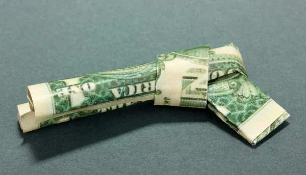 Dollar gevouwen in shirt op blauwe achtergrond — Stockfoto