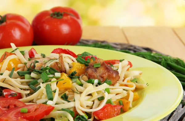 Noodles with vegetables in plates on bright background close-up — Stock Photo, Image