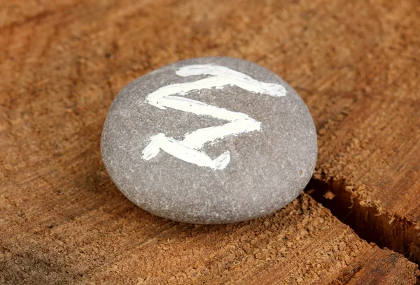 Fortune telling with symbols on stone on wooden background — Stock Photo, Image