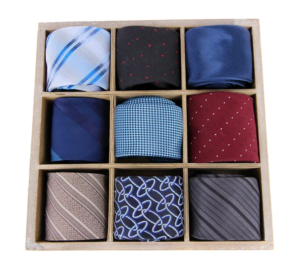 Neckties in wooden box isolated on white — Stok fotoğraf