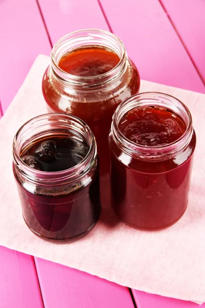 Tasty jam in banks on table — Stock Photo, Image