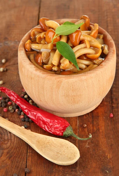 Mushrooms in bowl, on wooden background — Stock Photo, Image