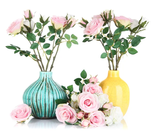 Beautiful pink and white roses in vases isolated on white — Stock Photo, Image