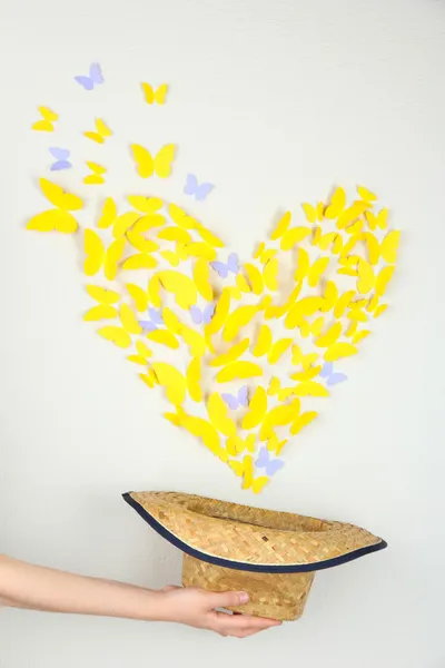 Paper yellow butterfly in form of heart fly out hat — Stock Photo, Image