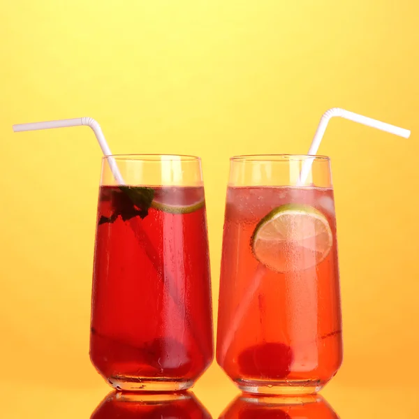 Dos cócteles de cereza con hielo sobre fondo naranja — Foto de Stock