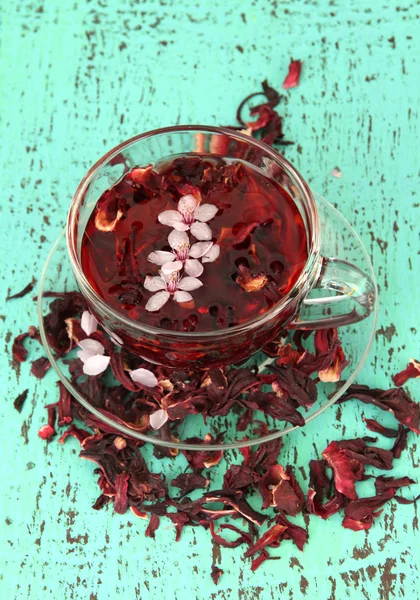 Herbal tea in glass cup, on color wooden background — Stock Photo, Image