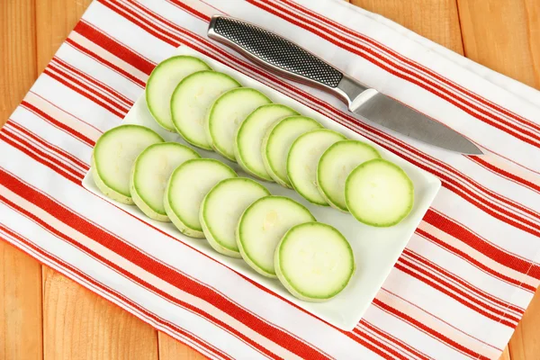Fresh marrows on plate, on wooden background — Stock Photo, Image