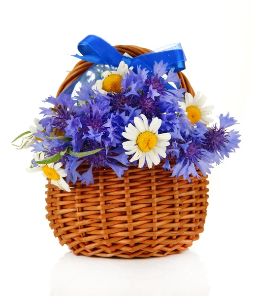 Beautiful bouquet of cornflowers and romomiles in basket, isolated on white — стоковое фото
