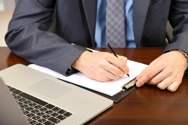 Young businessman in office at his workplace — Stock Photo, Image