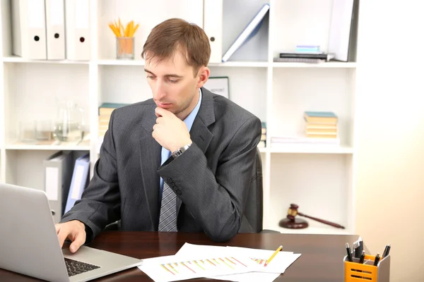 Young businessman in office at his workplace — Stock Photo, Image