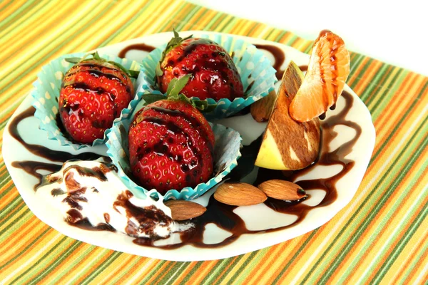 Fruit in chocolate on plate on tablecloth close-up — Stock Photo, Image