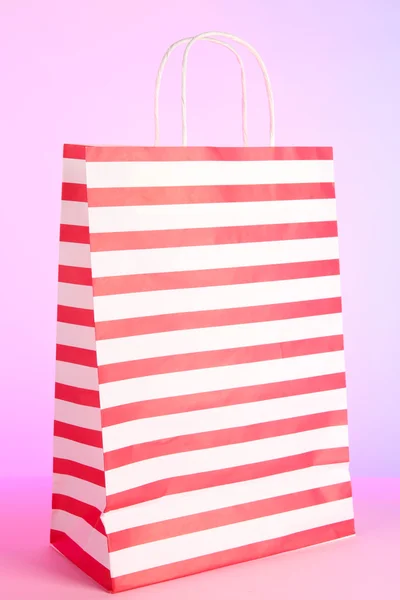 Strippad väskor på rosa bakgrund — Stockfoto