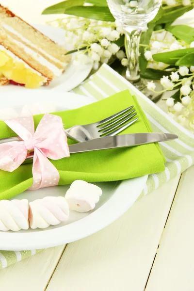 Table setting in white and green tones on color wooden background — Stock Photo, Image