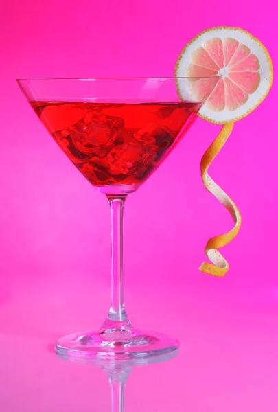 Red cocktail in martini glass on pink background — Stock Photo, Image