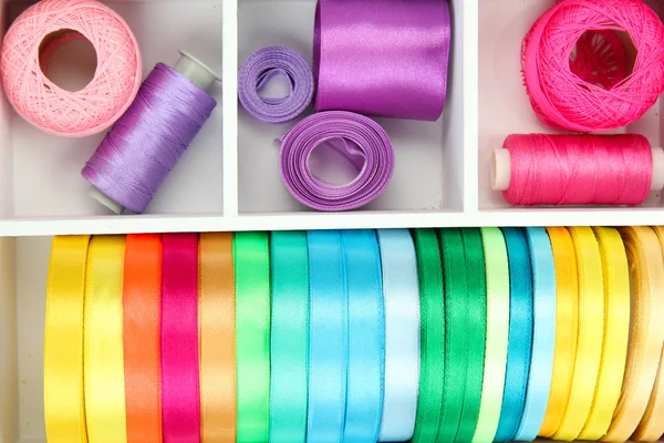 Material for sewing in white wooden box closeup — Stock Photo, Image