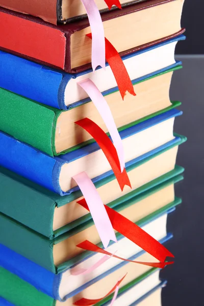 Many books with bookmarks on gray background — Stock Photo, Image