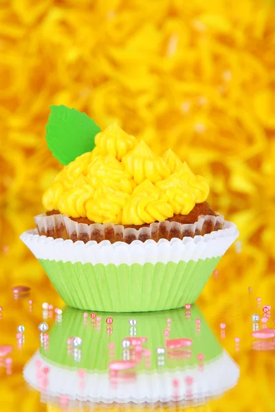 Delicious beautiful cupcake on decorative yellow background — Stock Photo, Image