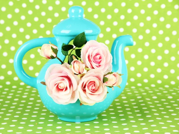 Pot with flowers on a green fabric background — Stock Photo, Image