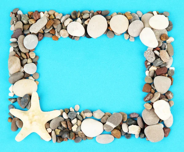 Frame of sea stones on color background — Stock Photo, Image