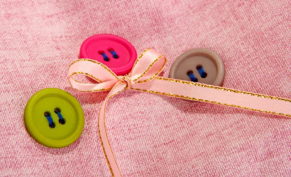 Three buttons on light cloth — Stock Photo, Image