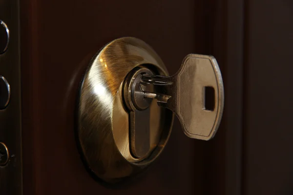 Door lock with key close-up — Stock Photo, Image